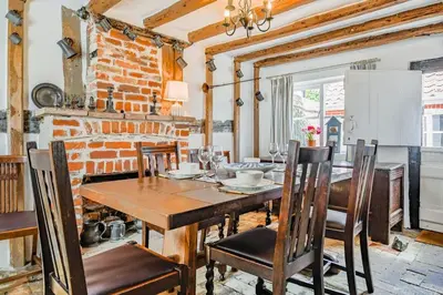 a dining room with a wooden table and chairs at 2 Bed in Aldeburgh oc-sfdar in Aldeburgh