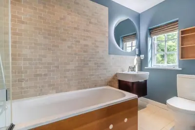 a bathroom with a tub and a sink at 3 Bed in Westleton Saxmundham oc-est in Westleton