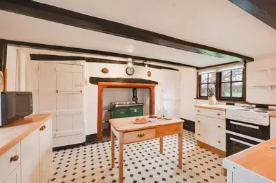 a kitchen with a table in the middle of it at 3 Bed in Hemley oc-g91 in Hemley