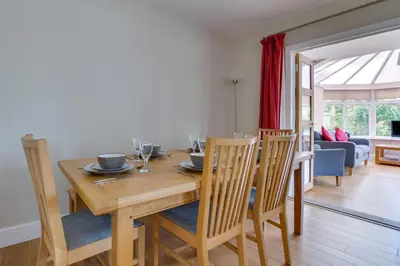 a dining room with a wooden table and chairs at 4 Bed in Hacheston oc-hac in Marlesford