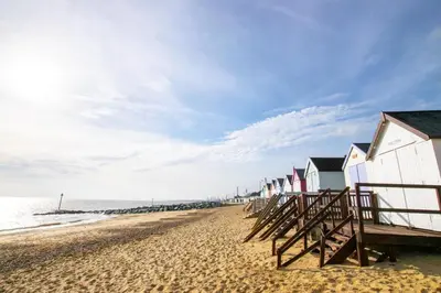 a row of beach houses on a sandy beach at 2 Bed in Felixstowe oc-hideo in Felixstowe