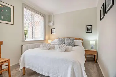 a bedroom with a white bed with two towels on it at 7 Bed in Aldeburgh oc-midba in Aldeburgh