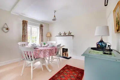 a dining room with a table and chairs and a fireplace at 2 Bed in Ufford oc-sfmcu in Ufford