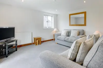 a living room with two couches and a flat screen tv at 5 Bed in Finningham oc-obhf in Finningham