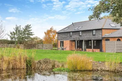 an old brick house next to a pond at 2 Bed in Yoxford oc-hploug in Yoxford