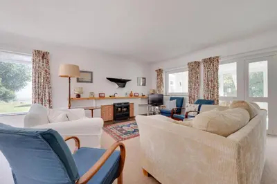 a living room with couches and chairs and a fireplace at 3 Bed in Aldeburgh oc-spr in Aldeburgh