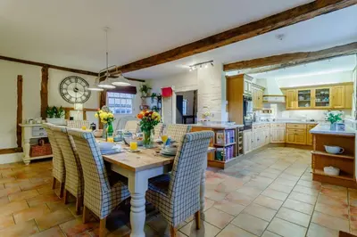 a kitchen and dining room with a table and chairs at 5 Bed in Metfield oc-stfarm in Metfield