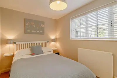a bedroom with a bed and a window at 4 Bed in Westleton oc-s27303 in Westleton