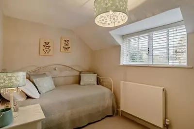 a bedroom with a bed and a desk and a window at 4 Bed in Westleton oc-s27303 in Westleton