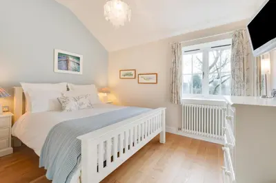 a bedroom with a white bed and a window at 2 Bed in Eye oc-slo in Wilby