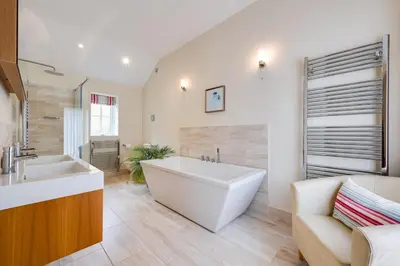 a large bathroom with a large tub and a sink at 3 Bed in Wilby oc-slowlo in Wilby