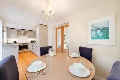 a dining room with a table and chairs and a kitchen at 3 Bed in Wilby oc-slowlo in Wilby