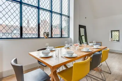 a dining room with a wooden table and chairs at 4 Bed in Thorpeness oc-cho in Thorpeness