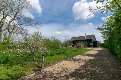 a house in a garden with a dirt road at 3 Bed in Debenham oc-thefol in Debenham