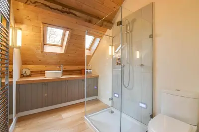a bathroom with a glass shower and a toilet at 3 Bed in Debenham oc-thefol in Debenham