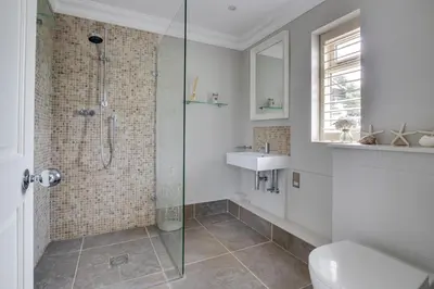 a bathroom with a shower and a toilet and a sink at 5 Bed in Orford oc-pav in Orford