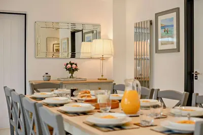 a dining room table with chairs and a mirror at 4 Bed in Aldeburgh oc-12lr in Aldeburgh