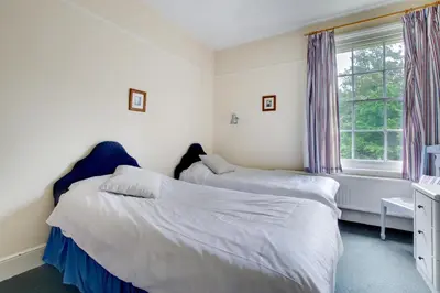 a bedroom with two beds and a window at 13 Bed in Tattingstone oc-tat26 in Tattingstone