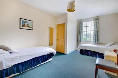 a bedroom with two beds and a window at 13 Bed in Tattingstone oc-tat26 in Tattingstone
