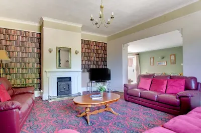a living room with two couches and a fireplace at 13 Bed in Tattingstone oc-tat26 in Tattingstone