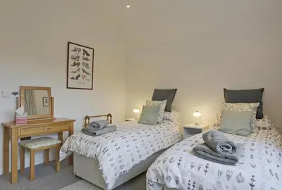 a bedroom with two twin beds and a mirror at 2 Bed in Leiston oc-cqa in Theberton