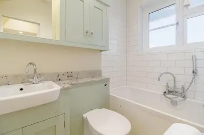 a white bathroom with a sink and a toilet at 3 Bed in Woodbridge oc-h23 in Woodbridge