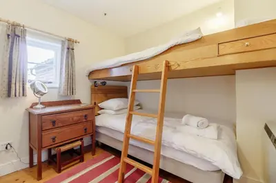 a bedroom with a bunk bed and a desk at 3 Bed in Woodbridge oc-h23 in Woodbridge