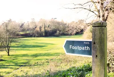 a blue sign on a pole in a field at 2 Bed in Woodbridge oc-csn2 in Woodbridge