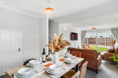 a dining room with a table and a couch at Grab a Deal Today! Massive Home For Contractors & Parking for 4 in Chelmsford