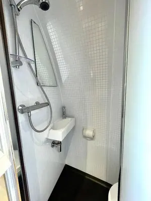a small bathroom with a sink and a shower at Armadilla 1 at Lee Wick Farm Cottages & Glamping in Clacton-on-Sea