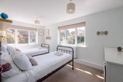 two beds in a room with two windows at Springfield, Westleton in Westleton