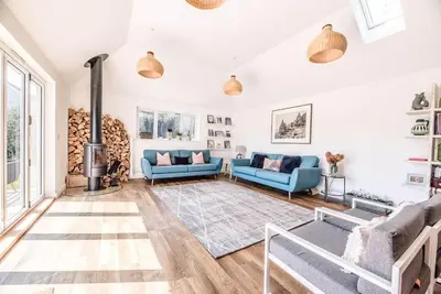 a living room with two blue couches and a fireplace at Springfield, Westleton in Westleton