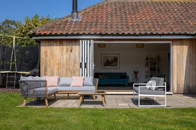 a patio with a couch and a table and a bench at Springfield, Westleton in Westleton