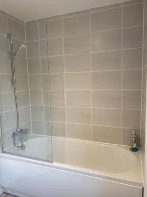 a bathroom with a shower and a bath tub at Comfortable new home in Isleham in Ely